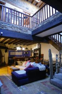 a large living room with a bed and a staircase at Orgullo Rural in Bermellar