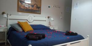 a bedroom with a blue bed with confetti on it at Il Sole del Mediterraneo in Noto