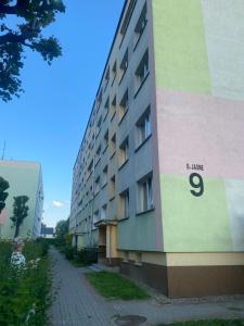 a building with a sign on the side of it at APARTAMENT OŚ. JASNE 9C in Dzierżoniów