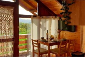 a dining room with a table and chairs and a window at The Treehouse of The Dragon in Ioannina