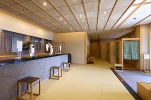 a lobby with a bar and stools at Onyado Nono Matsumoto Natural Hot Spring in Matsumoto
