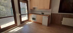 a kitchen with a sink and a stove at Casa Melitona in Castiello de Jaca