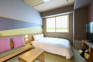 a small room with a bed and a tv at Onyado Nono Matsumoto Natural Hot Spring in Matsumoto