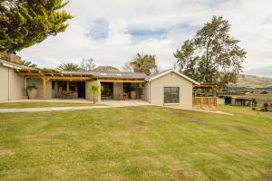 a house with a large yard in front of it at Kouwdouw Guest Farm in George