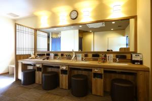 a bathroom with a large vanity with a large mirror at Onyado Nono Matsumoto Natural Hot Spring in Matsumoto