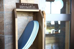 a wooden shelf with a blue plate in it at Onyado Nono Matsumoto Natural Hot Spring in Matsumoto
