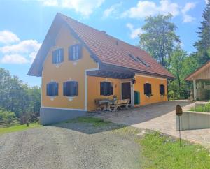 a small house with a patio in front of it at Die Hube in Leutschach