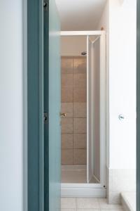 a bathroom with a shower with a glass door at FONTE D'OLIO CONERO RELAIS in Sirolo +34 photos