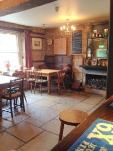 a dining room with a table and chairs and a chalkboard at The Royal Oak Burford in Burford