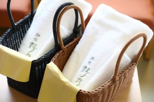 a basket filled with white towels on a table at Onyado Nono Matsumoto Natural Hot Spring in Matsumoto