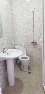 a bathroom with a toilet and a sink at Mate's GUEST HOUSE in Kobuleti