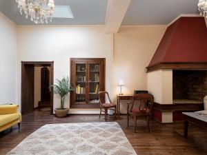a living room with a fireplace and a table and chairs at Old Town Suites in Chania Town