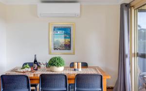 a dining room with a table and chairs at Carrawaves 73 LaRonde in Carrickalinga