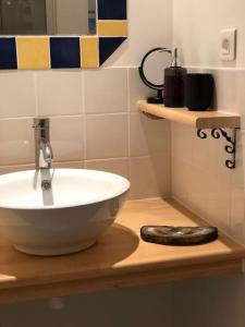 a bathroom with a white bowl sink on a counter at Gîte de l'hortensia-Charmante maison de campagne au calme in Gourville