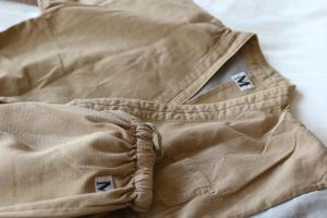 a pair of khaki pants sitting on a bed at Onyado Nono Matsumoto Natural Hot Spring in Matsumoto
