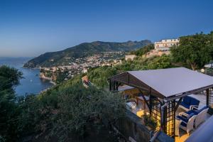 a train station on a hill next to a body of water at Villa Denise in Vico Equense