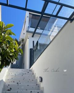 una escalera que conduce a un edificio con techos de cristal en THE CUBE, en Pisak