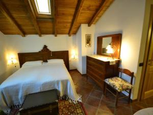 a bedroom with a bed and a dresser and a mirror at Scenic apartment in Vezzi Portio with private garden in Vezzi Portio