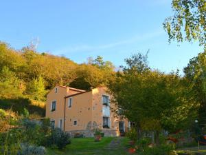 a house in the middle of a garden at Scenic apartment in Vezzi Portio with private garden in Vezzi Portio