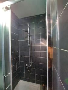 a shower with a glass door in a bathroom at Anna Guesthouse 10 min walk from the beach in Larnaca