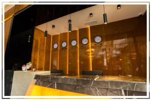 a row of clocks on a wall in a room at Premium Hotel Ganja in Ganja +93 photos