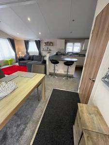 a living room and kitchen with a couch and a table at Luxury Lodge in Heysham