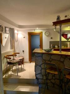 a kitchen and dining room with a stone counter and chairs at Studio Roxi in Bachowice