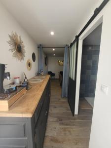 a kitchen with a wooden counter top in a room at Les gîtes de ninon in Moult