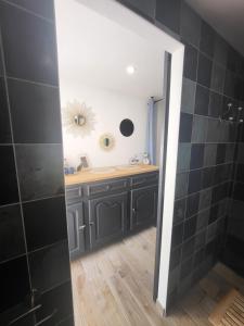 a bathroom with a shower and a sink and a mirror at Les gîtes de ninon in Moult