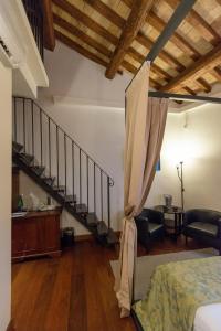 a bedroom with a staircase and a bed in a room at Relais Giulia in Rome
