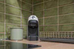 a hair dryer sitting on a shelf in a kitchen at Filia Solis - Old Town SUITEs & SPA in Brindisi