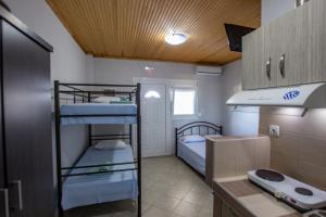 a small room with two bunk beds in it at Studios ORAMA in Nea Vrasna