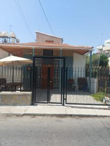 a gate in front of a house with a patio at Anna Guesthouse 10 min walk from the beach in Larnaka