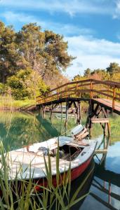 a boat sitting in the water next to a bridge at Apartments Cungu in Ulcinj