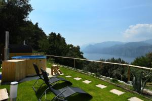 a garden with a view of the water and mountains at Apartment " Flower of Life" in Malcesine