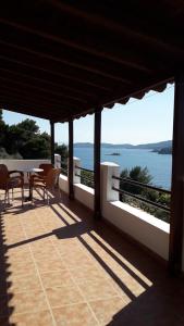 a balcony with a table and chairs and the ocean at Ourania Sea Breath in Punta