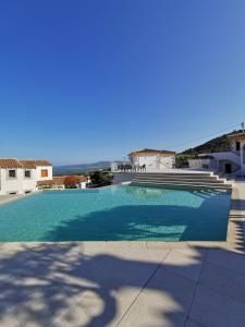 a large swimming pool with a view of the ocean at Residence Chiaro di Luna in San Teodoro
