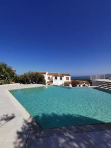 a swimming pool in a villa with a view of the ocean at Residence Chiaro di Luna in San Teodoro