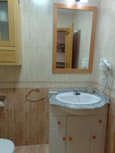 a bathroom with a sink and a mirror at A PONTE in Padrón +38 photos
