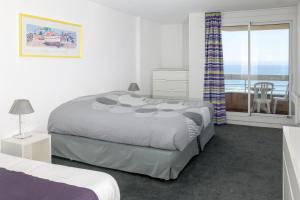 Een bed of bedden in een kamer bij Résidence Victoria Surf