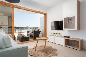 a living room with a couch and a table at Beachside Alcudia in Port d'Alcudia