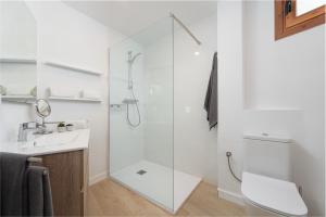 a bathroom with a shower and a toilet and a sink at Beachside Alcudia in Port d'Alcudia +23 photos