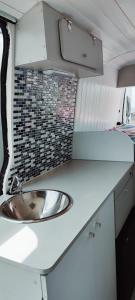 a bathroom with a sink in an rv at Se alquila magnifica Camper in Costa Teguise