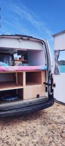 a van with its door open on the beach at Se alquila magnifica Camper in Costa Teguise