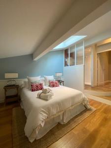 sypialnia z dużym białym łóżkiem z czerwonymi poduszkami w obiekcie LES CHAMBRES DE MARIE w mieście Bordeaux