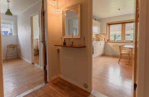 un corridoio di una casa con specchio e tavolo di Scenic Village / Nature / Cozy House / 4 BR a Viðareiði