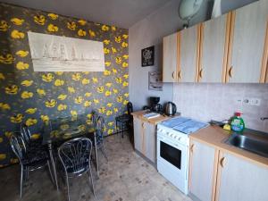 a kitchen with yellow flowers on the wall at Apartment Martin in Šilo