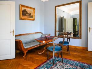 a living room with a table and a couch and a mirror at Zamek w Krokowej in Krokowa