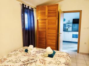 a bedroom with a bed with towels on it at Sweet Apartment With Private Pool Lori Ankaran in Ankaran