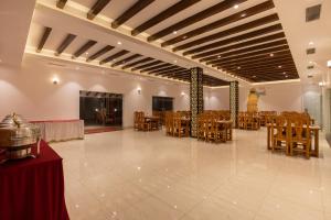 a banquet hall with wooden tables and chairs at Manigram Bishram Batika Pvt Ltd in Bhairahawa
